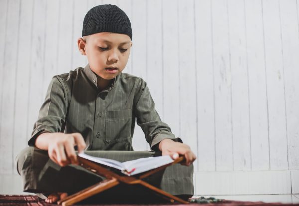 asian-muslim-boy-wearing-traditional-costume-called-gamis-reading-holy-book-alquran-scaled.jpg