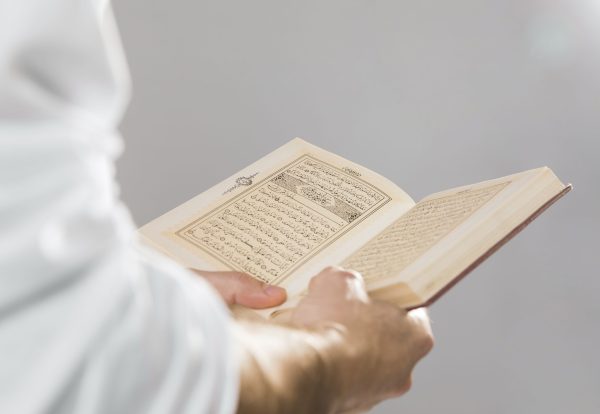 religious-muslim-book-being-held-hands-scaled.jpg