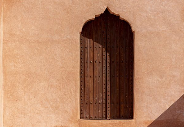 traditional-arabian-architecture-muslim-style-wooden-door-red-clay-wall-scaled.jpg